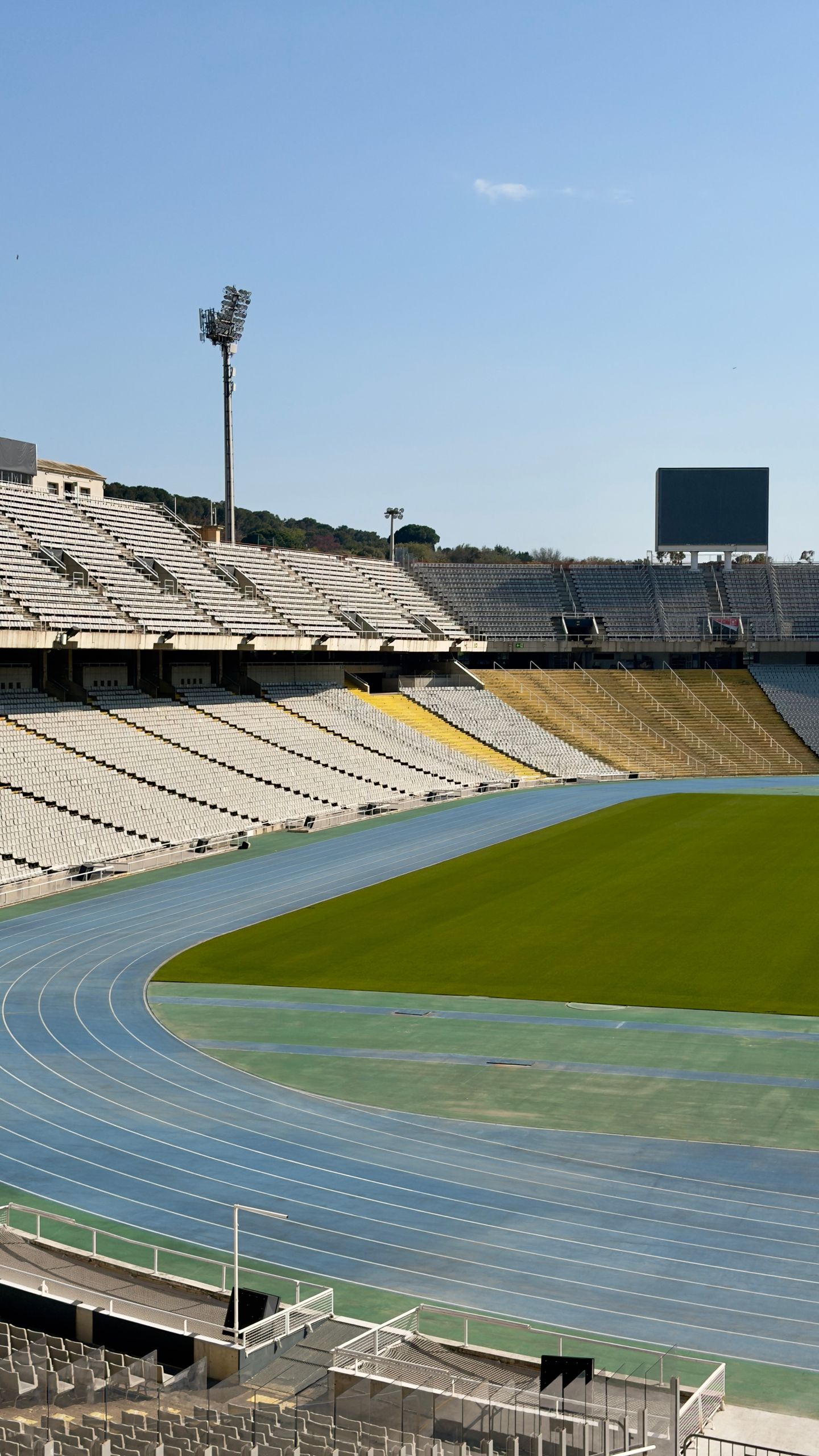 Aerial view of the vacant Olympic stadium in Barcelona, showcasing the running track and stands.